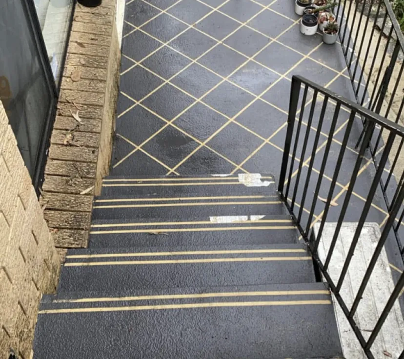 Tiled entry and stairs after pressure cleaning — mould and grime removed, pattern crisp